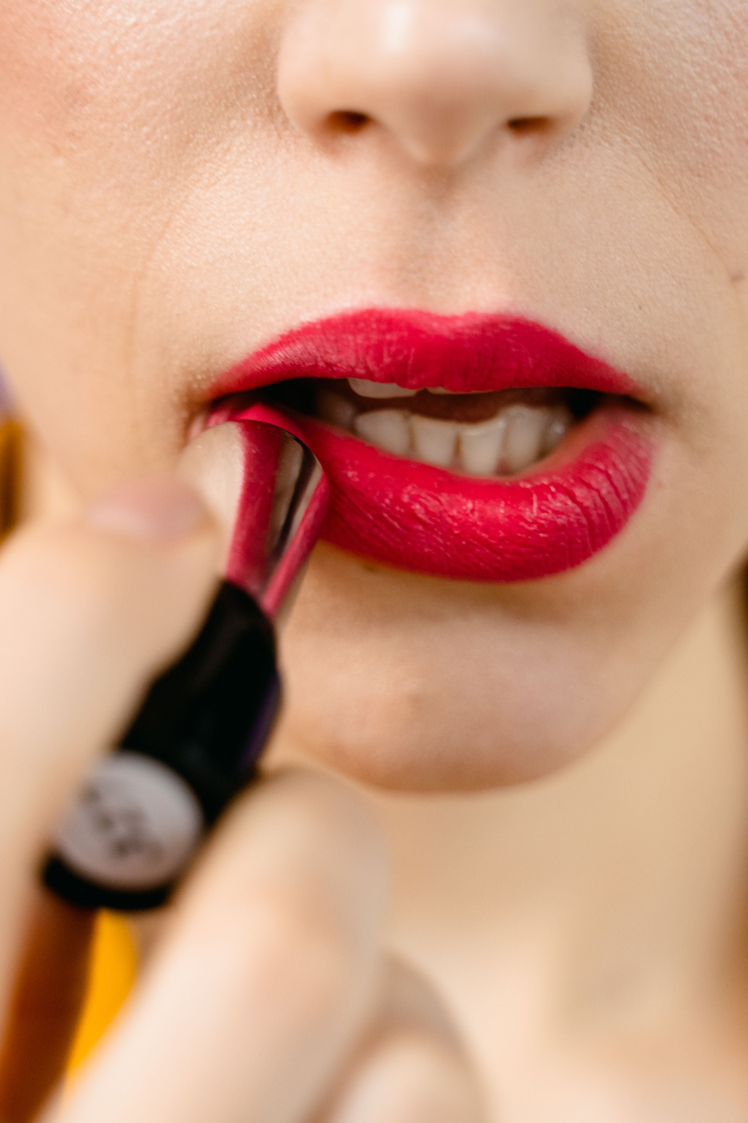Woman applying lipstick